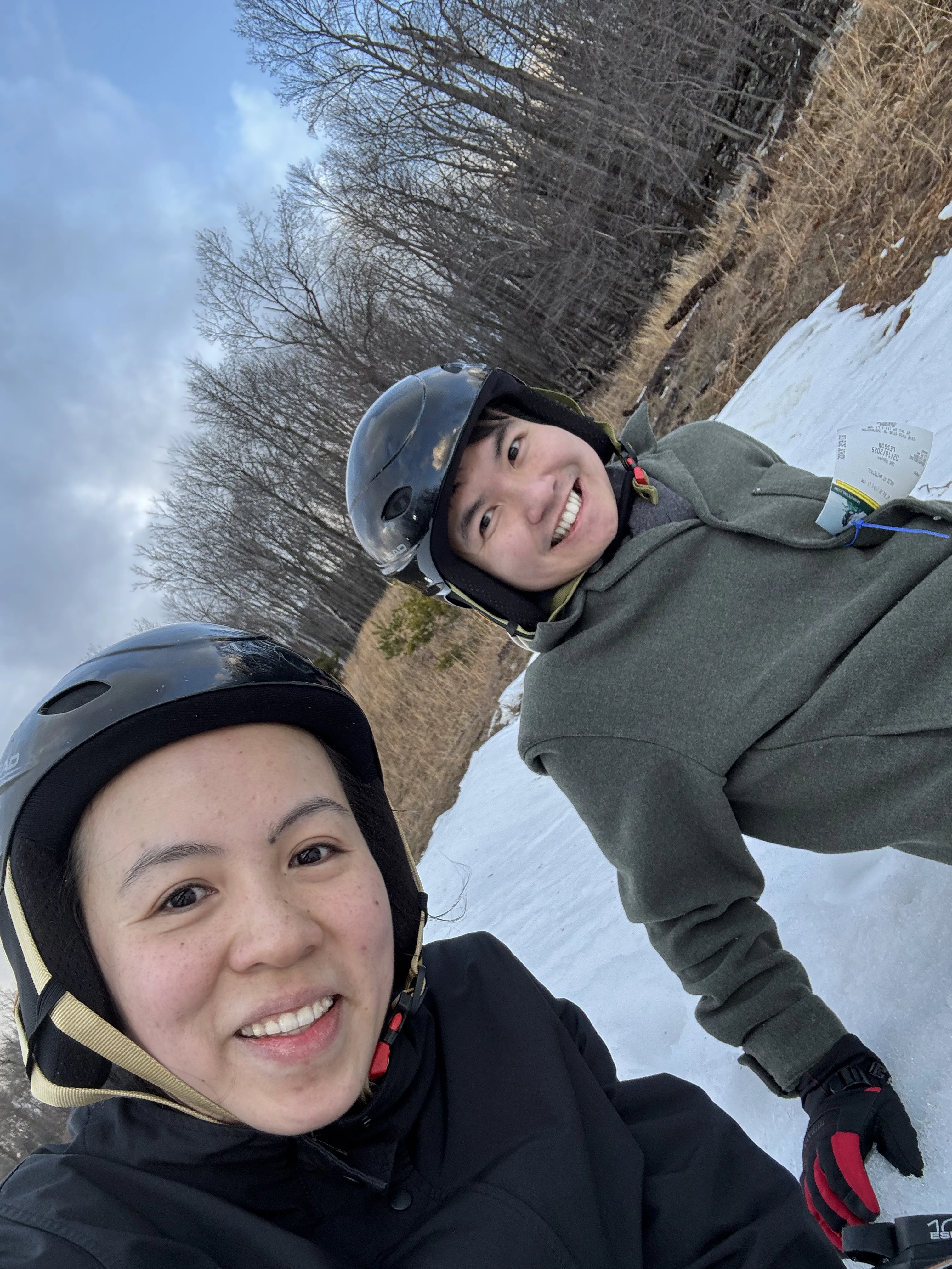 Two tropical Asians confidently attempting winter sports.